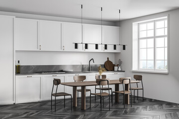 White kitchen set with eating table and chairs on black parquet floor