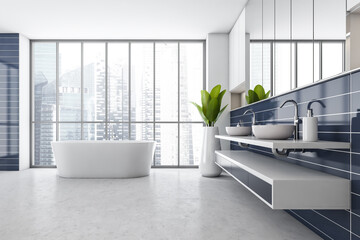 Obraz na płótnie Canvas White and blue bathroom with two sinks and bathtub near window