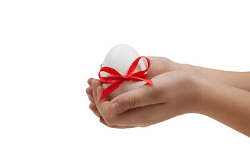 white easter egg tied with a red ribbon with a bow in the palms of the hands on a white background isolated