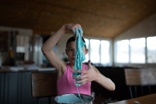Tween making blue slime at home