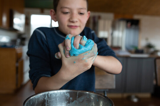 Close up of boy squeezing slime with his hands