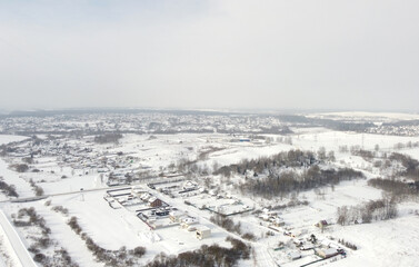 Top view of rural landscape with snow covered field in winter