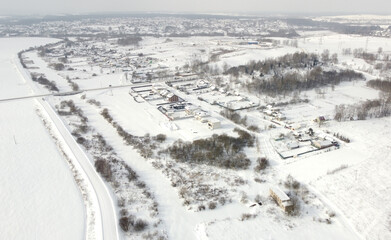 Top view of rural landscape with snow covered field in winter