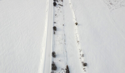 Top view of rural snowy road in winter