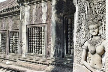 Carving of a dancing female divinity or apsara on the outer wall of Angkor Wat in Cambodia