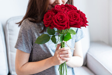 women get a bouquet of red roses