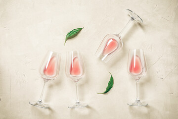 Glasses with rose wine flat lay on a concrete background. View from above.