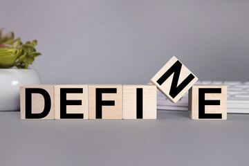 DEFINE. text on wood cubes on gray background