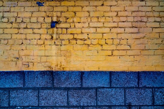 Brick wall painted yellow and blue background