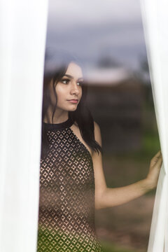 Pretty brunette looking out the window.