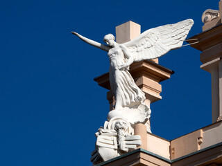 victory fascism angel statue on the top of old building