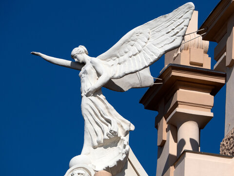 victory fascism angel statue on the top of old building