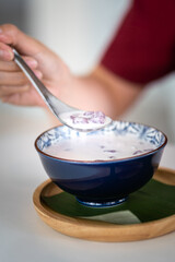 Action of people hand is using a stainless steel spoon to eating 