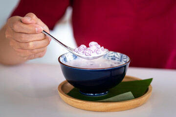 Action of people hand is using a stainless steel spoon to eating 