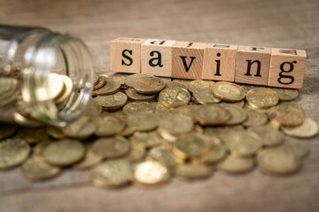 Creative saving money concept with golden coin on shabby wooden board background.