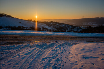 Road with snow in winter vineyard landscape