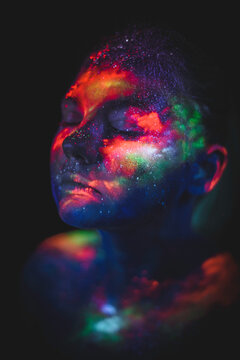 Conceptual shot of light and shine fluorescent colors young girl's fac