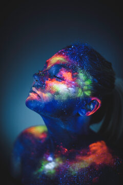 Conceptual shot of light and shine fluorescent colors young girl's fac