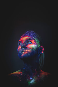 Conceptual shot of light and shine fluorescent colors young girl's fac