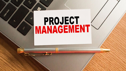 Notepad with inscriptions PROJECT MANAGEMENT on a white background. business concept.