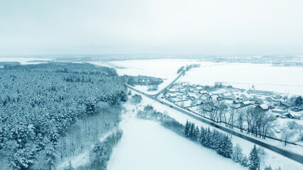Aerial view from drone on blue snowy suburb in winter