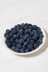 fresh farm blueberries on white background, vertical