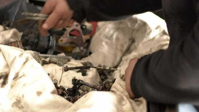 The Craftsman Serviceman Car  In The Repair Shop Lets The Suitable Screws While Gathering