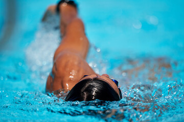 Close up of swimmer doing backstroke at outdoor swimming pool