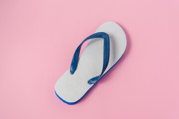 A white sandals on light pink background.