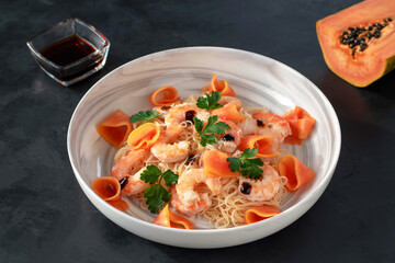 Funchose salad with prawns, papaya, herbs and soy sauce.