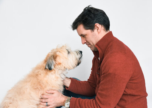 Profile Of Man And Dog Looking At Eachother Against A White Background