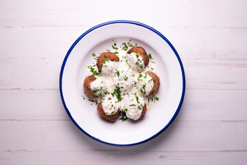 Greek meatballs with tzatziki cooked in a restaurant.