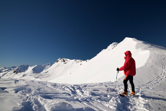 Mountaineer hiking in the Pyrenees in winter season.