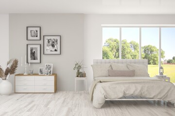 Fototapeta premium Stylish bedroom in white color with summer landscape in window. Scandinavian interior design. 3D illustration