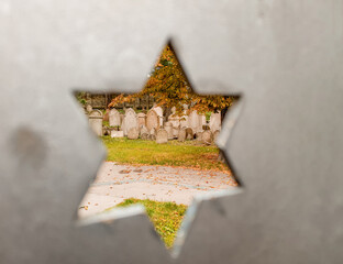 View of the cemetery through the Jewish six-pointed star of David carved into the stone wall (193)