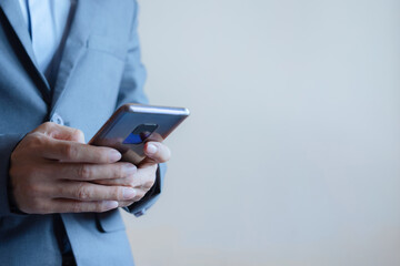 close up of business man hand using smart phone touch on screen and typing for some searching internet information technology data.