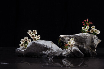 Grey marble stone podium with white tiny flowers, water as shore at night for packaging and...