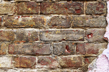The texture is a old, obsolete, ruined brick wall. brickwork. dark bricklaying and light plaster from cement.