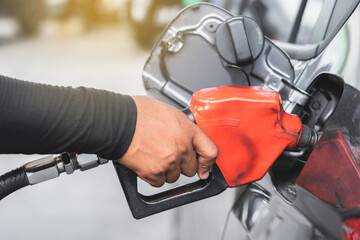 Hand of attendant holding refueling car