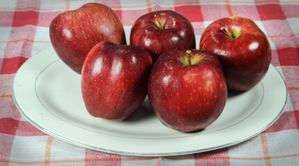 Red apples on a plate