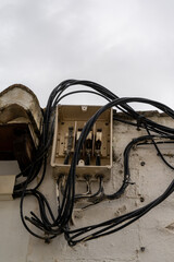 Fototapeta na wymiar open electrical station with many cables leading in and out in an unsafe and haphazard manner