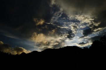 the view of the dark sky and the silhouette of the mountains