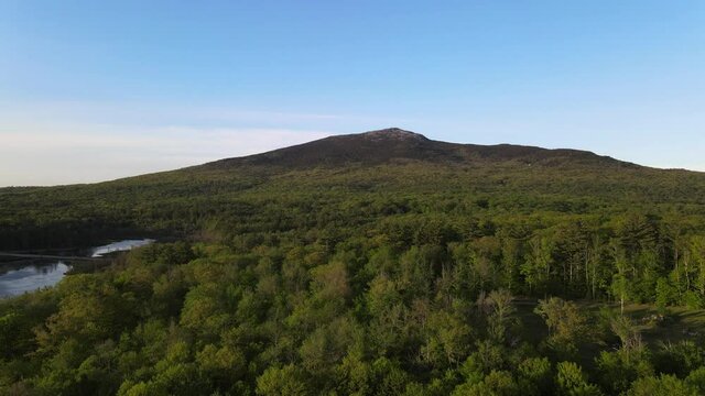Iconic ridgeline of Mount Monadnock in New England in late afternoon. Aerial 4K drone video filmed near Perkins Pond in Jaffrey, New Hampshire.