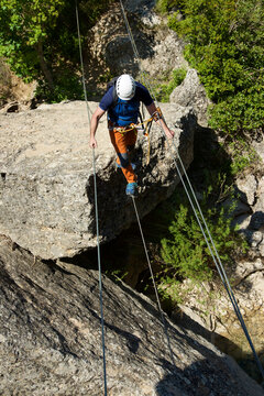 Crossing a suspension bridge in Bierge in Guara Mountains.