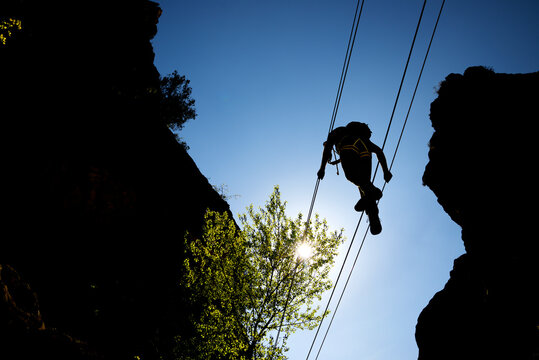Crossing a suspension bridge in Bierge in Guara Mountains.