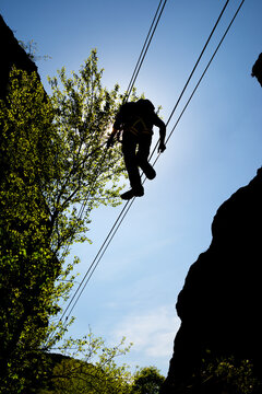 Crossing a suspension bridge in Bierge in Guara Mountains.