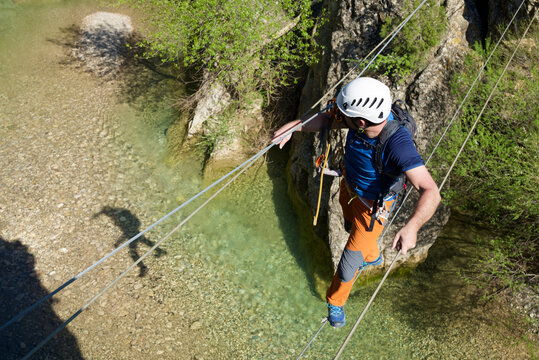 Crossing a suspension bridge in Bierge in Guara Mountains.