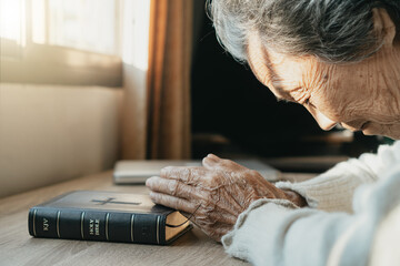 Elderly Asian women are praying for blessings from God.