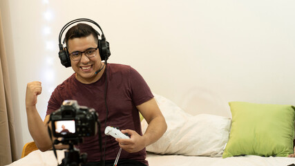 Young fat streamer gamer playing video game competition - Male guy having fun gaming and streaming...