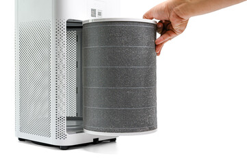 Man hold a old Filter of  the air purifier check with change filter in side air purifier for dust...